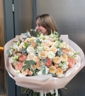 Bouquet with peony roses, roses, lisianthus (eustoma) combined with fragrant eucalyptus